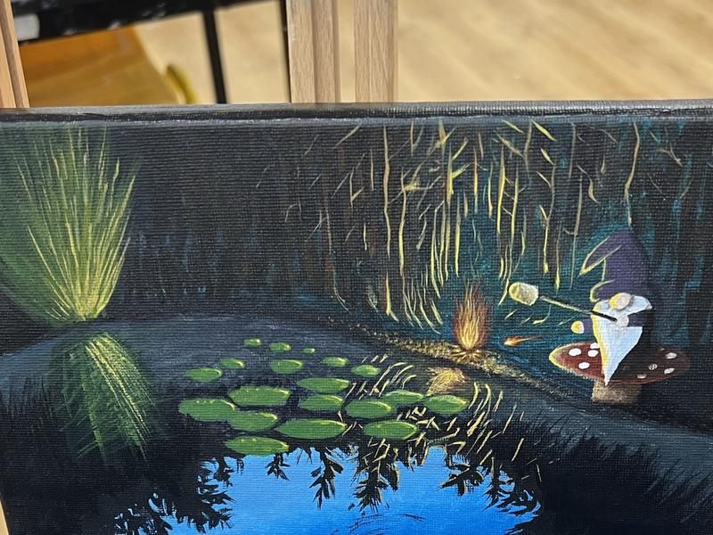 An acrylic painting in progress on an easel in the studio