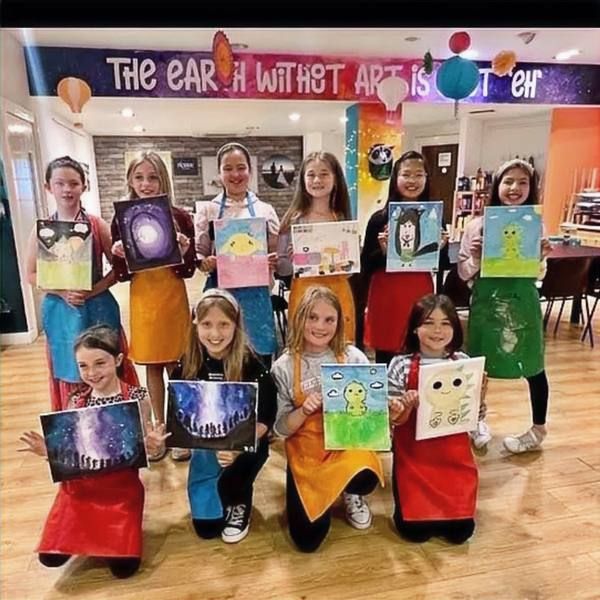 A group of children with their finished canvases