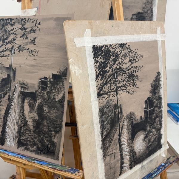 Charcoal drawings of trees on studio easels