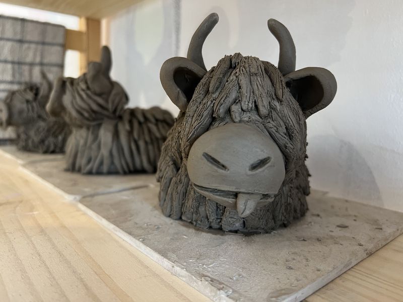 Hand-built clay Highland cow with a textured shaggy coat